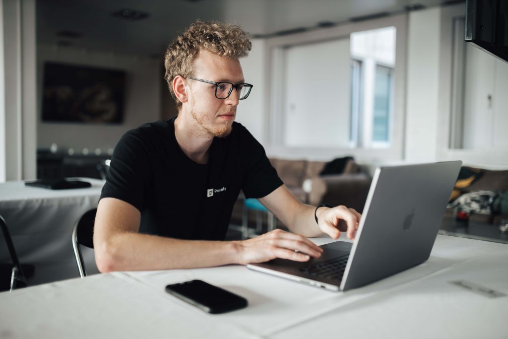 Australian business owner working on a laptop, symbolizing how to outsource a virtual assistant in Australia.