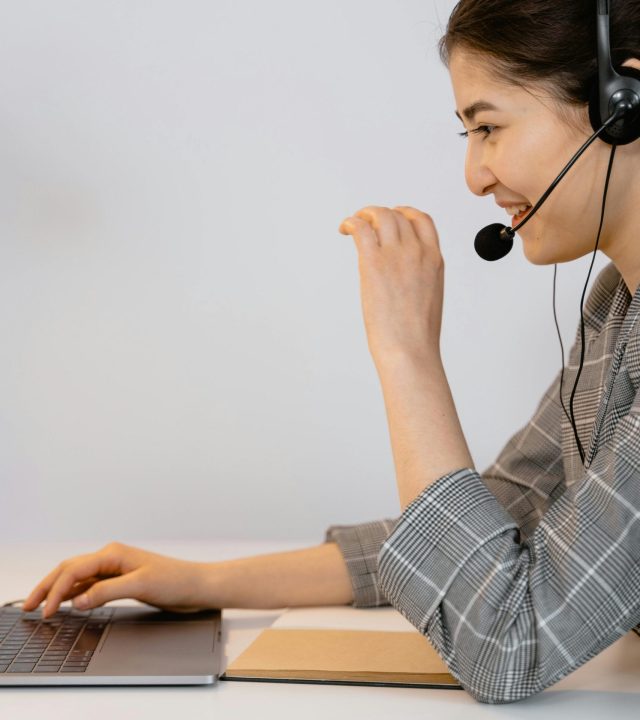 Customer support specialist handling calls via headset under an offshore staffing Philippines standard scaling plan